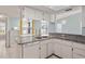 Kitchen area with granite countertops, white cabinets and view to sunny dining nook at 3857 Sailmaker Ln, Holiday, FL 34691