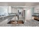 Bright kitchen featuring stainless steel appliances, granite countertops, and a modern faucet at 3857 Sailmaker Ln, Holiday, FL 34691