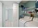 Efficient laundry room featuring a washer, dryer, and shelving for convenient storage at 3857 Sailmaker Ln, Holiday, FL 34691