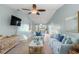 Bright living room with vaulted ceilings, tile floors, ceiling fan, and stylish furnishings at 3857 Sailmaker Ln, Holiday, FL 34691