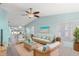 Bright living room featuring a ceiling fan, tile flooring, and comfortable seating arrangement at 3857 Sailmaker Ln, Holiday, FL 34691