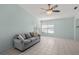 Light and airy living room with vaulted ceiling, neutral tile flooring, and gray sofa at 3857 Sailmaker Ln, Holiday, FL 34691