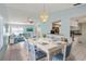 Open living space featuring a dining area and living room with cohesive blue and white color scheme at 3857 Sailmaker Ln, Holiday, FL 34691