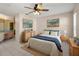 Main bedroom showcasing tasteful decor, ceiling fan, and access to the bathroom at 3857 Sailmaker Ln, Holiday, FL 34691