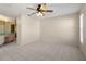 Large main bedroom with tile flooring, ceiling fan, and access to the bathroom at 3857 Sailmaker Ln, Holiday, FL 34691