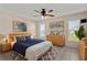 Cozy main bedroom featuring neutral tones, ceiling fan, and bright natural light at 3857 Sailmaker Ln, Holiday, FL 34691