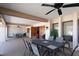 This covered patio features an outdoor table with seating and a view to the exterior landscaping at 3857 Sailmaker Ln, Holiday, FL 34691