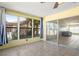 Enclosed sunroom with many large windows at 3857 Sailmaker Ln, Holiday, FL 34691