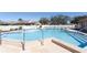 A well-maintained swimming pool offers a refreshing escape, complemented by lounge chairs and lush landscaping at 3857 Sailmaker Ln, Holiday, FL 34691