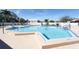 A refreshing swimming pool with clear blue water is surrounded by lounge chairs, perfect for relaxation at 3857 Sailmaker Ln, Holiday, FL 34691