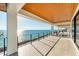 Expansive balcony offering ocean views with tile floors, modern railing, and wood ceiling at 4005 Casey Key Rd, Nokomis, FL 34275