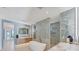 Spa-like bathroom with double sinks, soaking tub, marble walls, and modern fixtures at 4005 Casey Key Rd, Nokomis, FL 34275