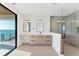 Bathroom features a double vanity, walk-in shower and exterior balcony with water view at 4005 Casey Key Rd, Nokomis, FL 34275