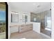 Bright bathroom boasts a double vanity, walk-in shower and exterior balcony access at 4005 Casey Key Rd, Nokomis, FL 34275