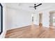Bright bedroom with hardwood floors, a walk-in closet, and a modern ceiling fan at 4005 Casey Key Rd, Nokomis, FL 34275