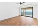 Bright, open bedroom features an exterior balcony with a water view at 4005 Casey Key Rd, Nokomis, FL 34275