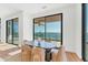 Modern dining room with ocean views, a contemporary table, and stylish chairs at 4005 Casey Key Rd, Nokomis, FL 34275