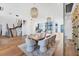 Open concept dining room with modern décor, hardwood floors, and a view to the living area at 4005 Casey Key Rd, Nokomis, FL 34275