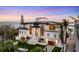 Impressive home with manicured lawns and palm trees, complemented by picturesque views of the ocean at 4005 Casey Key Rd, Nokomis, FL 34275