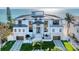 Stunning beachfront home with modern design, lush landscaping, and direct ocean views at 4005 Casey Key Rd, Nokomis, FL 34275