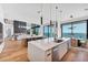 Open kitchen with large island, stainless steel appliances, and views of the living room and ocean at 4005 Casey Key Rd, Nokomis, FL 34275