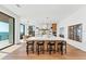 Bright and airy kitchen with island seating, modern appliances, and sliding glass doors to the ocean at 4005 Casey Key Rd, Nokomis, FL 34275