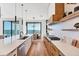 Galley kitchen with marble countertops, stainless steel appliances, and views of the ocean and dining area at 4005 Casey Key Rd, Nokomis, FL 34275