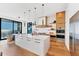 Modern kitchen with marble countertops, stainless steel appliances, and views of the ocean at 4005 Casey Key Rd, Nokomis, FL 34275
