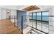 Modern living room with a fireplace, hardwood floors, large windows, and ocean views at 4005 Casey Key Rd, Nokomis, FL 34275
