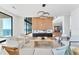 Open concept living room with modern furnishings, a statement fireplace, and ocean views at 4005 Casey Key Rd, Nokomis, FL 34275