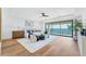 Spacious primary bedroom with ocean views, hardwood floors, and modern decor at 4005 Casey Key Rd, Nokomis, FL 34275