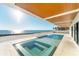 An inviting in-ground pool and jacuzzi with ocean views and a covered patio area at 4005 Casey Key Rd, Nokomis, FL 34275