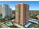 A stunning view of a highrise red brick condo building with community pool and covered parking at 4015 Bayshore Blvd # 11A, Tampa, FL 33611