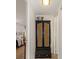Hallway view with a bedroom on the left, neutral walls, and a stylish storage cabinet at 4015 Bayshore Blvd # 11A, Tampa, FL 33611