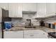 Functional kitchenette design with white cabinetry, mosaic backsplash, and granite countertops at 4015 Bayshore Blvd # 11A, Tampa, FL 33611