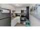 Modern kitchenette featuring stainless steel appliances, white cabinetry, and mosaic backsplash at 4015 Bayshore Blvd # 11A, Tampa, FL 33611