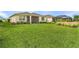 Expansive backyard featuring lush grass and a screened-in lanai, perfect for outdoor living and entertaining at 42211 Edgewater Dr, Punta Gorda, FL 33982