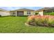 Beautiful backyard with manicured lawn and pink ornamental grass, creating a serene and private outdoor space at 42211 Edgewater Dr, Punta Gorda, FL 33982