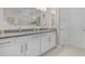 Bright bathroom featuring double sinks, modern fixtures, and white cabinetry at 42211 Edgewater Dr, Punta Gorda, FL 33982