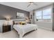 Cozy bedroom with a large window, gray accent wall, modern decor, and tile flooring at 42211 Edgewater Dr, Punta Gorda, FL 33982