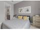 Cozy bedroom with grey walls, stylish art, and an ensuite bathroom at 42211 Edgewater Dr, Punta Gorda, FL 33982