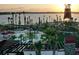 Stunning view of the community pool area and lake, with lounge seating and palm trees at sunset at 42211 Edgewater Dr, Punta Gorda, FL 33982