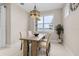 Inviting dining area with natural light, stylish chandelier, wooden table, and comfortable seating at 42211 Edgewater Dr, Punta Gorda, FL 33982