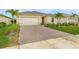 Charming home with a paved driveway, lush landscaping, and a two-car garage at 42211 Edgewater Dr, Punta Gorda, FL 33982