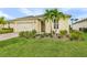 Attractive home with a well-maintained lawn, neat landscaping, and a welcoming entrance at 42211 Edgewater Dr, Punta Gorda, FL 33982