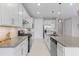 Spacious kitchen with stainless steel appliances, modern cabinetry, tile backsplash and stone countertops at 42211 Edgewater Dr, Punta Gorda, FL 33982