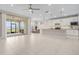 Spacious living room with an open floor plan, seamlessly connecting to the modern kitchen and screened patio with water views at 42211 Edgewater Dr, Punta Gorda, FL 33982