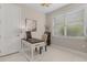 Well-lit home office featuring a wood desk, neutral walls, and a bright window view at 42211 Edgewater Dr, Punta Gorda, FL 33982