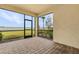 Relaxing screened patio featuring brick pavers, offering a tranquil view of the lake and lush landscaping at 42211 Edgewater Dr, Punta Gorda, FL 33982