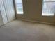 Bright bedroom featuring neutral carpet, double closets, and natural light from two windows at 4314 Live Oak Blvd, Palm Harbor, FL 34685